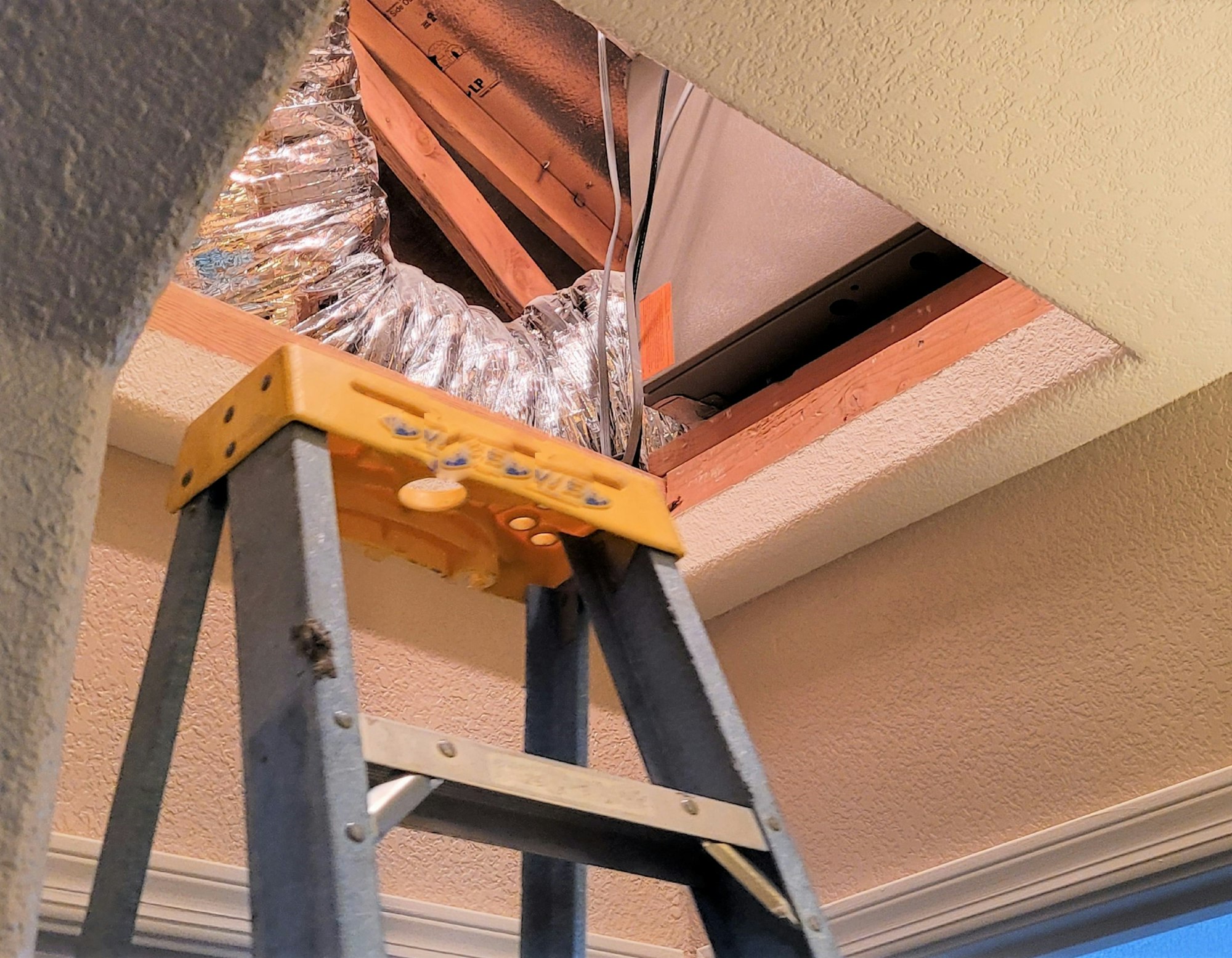 HVAC Technician Installing The Coil in the Attic Crawl Space!